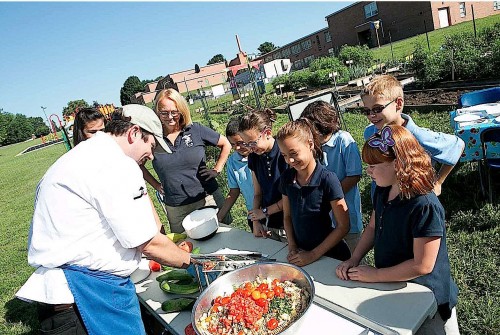 Smart Partners' Bill Scepansky prepares pasta salad with students from Hamilton Elementary School in the School District of Lancaster. (Lancaster County magazine/Nick Gould)