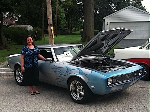 Contest winner Jessica Goss with 1968 Chevrolet Camaro SS, which is silver with cobalt blue pearl flames.